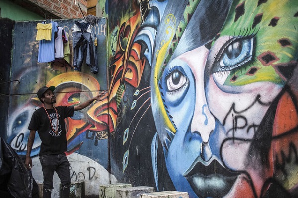 Ảnh: Juancho Torres Cách đây 25 năm, xung quanh đường Comuna 13 là khu ổ chuột với những ngôi nhà lụp xụp, người dân phải sống trong nghèo khổ. Nay đường Comuna 13 được hồi sinh và tràn đầy sức sống khi được khoác lên mình "chiếc áo nghệ thuật đường phố".