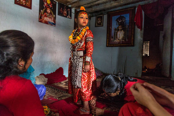 Đến với một con phố nhộn nhịp tại Patan, Nepal, du khách có thể may mắn tìm thấy một tấm bảng nhỏ với dòng chữ viết tay chỉ dẫn nơi thánh sống đang ngự. Một vị thánh mới lên 7. Ảnh: Stephanie Sinclair.