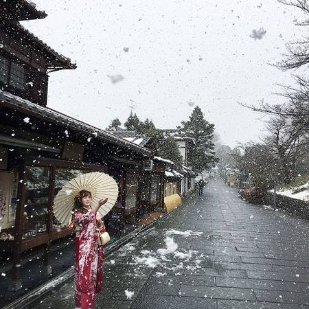 Thiếu nữ Nhật Bản xinh đẹp trong trang phục kimono khẽ khàng vươn tay hứng lấy những bông tuyết trắng, khiến cảnh sắc mùa đông như bớt đi cái lạnh giá