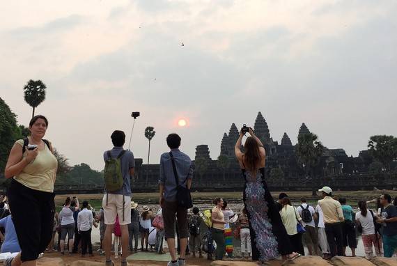 Khi đặt chân tới Angkor Wat, bạn sẽ ngỡ ngàng khi thấy đã có rất nhiều người có mặt ở khu vực hồ soi bóng đền. Những người Khmer bán hàng rong chào mời từ cà phê đến cơm rang.
