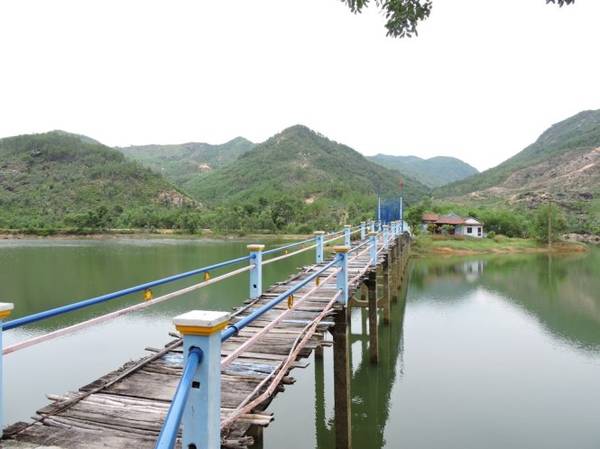 Chiếc cầu gỗ bắc ngang qua mặt hồ, đưa du khách tham quan các đồi núi xung quanh hồ - Ảnh: T.Ly