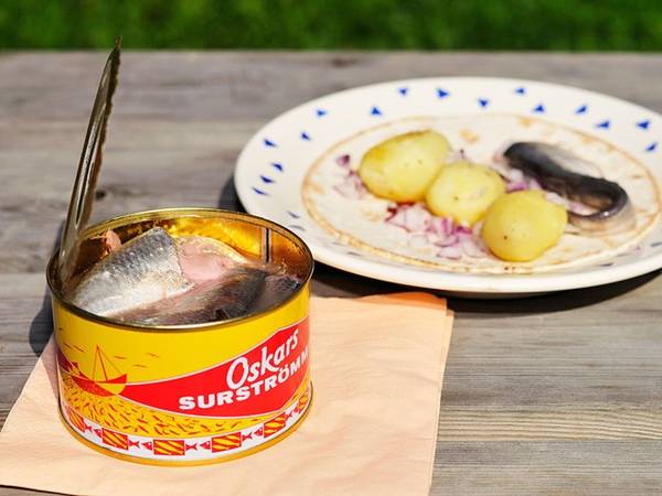 <strong>Surströmming (Thụy Điển):</strong> Món cá trích thối thách thức ngay cả những người can đảm nhất. Mùi của món Surströmming khó ngửi tới mức mọi người phải đem hộp cá ra ngoài trời mới dám mở. Ảnh: CNTraveler.
