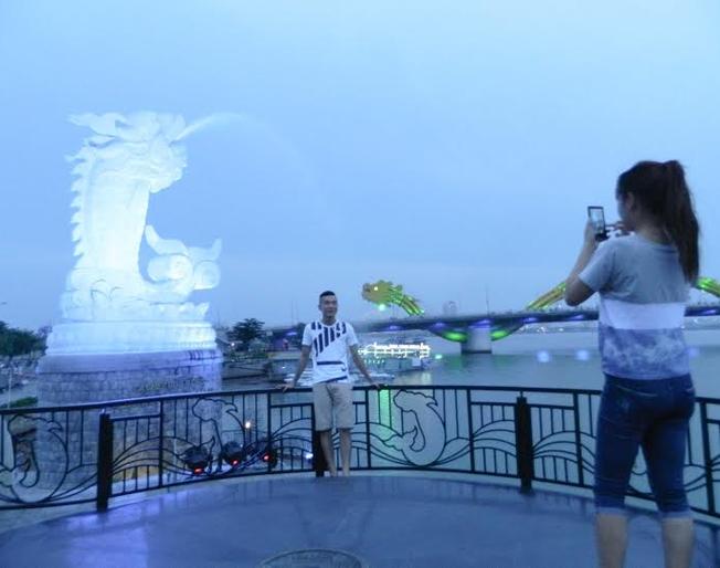 Du khách bị thu hút bởi bức tượng Cá chép hóa rồng