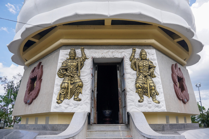 Sau lưng bức tượng Kim Thân Phật tổ có lối vào, hai bên cửa tạc tượng hai vị thần hộ pháp.