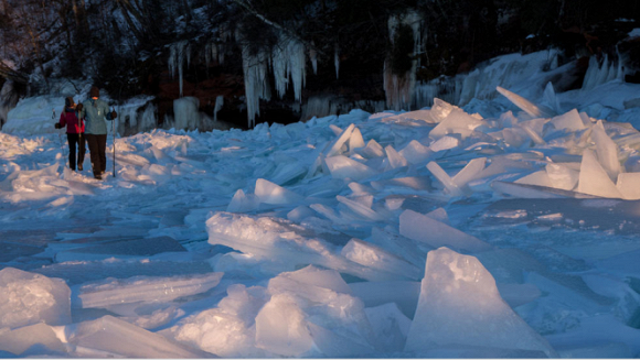 Du khách di chuyển trên hồ băng Lake Superior để đến tham hang băng. 